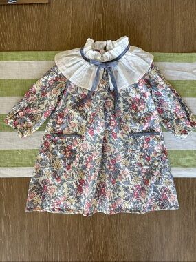 La Coqueta floral girls dress with a bib and bow, fully lined